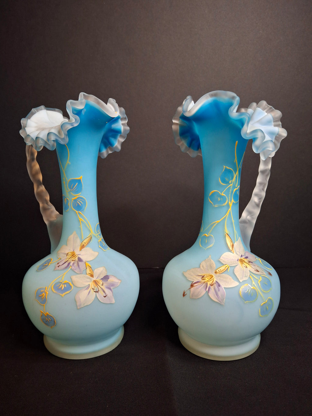 Antique Pair Victorian Blue Satin Cased Glass Pitcher Ewers Hand Painted Orchids Frosted Coral Branch Handles Ruffled Rim