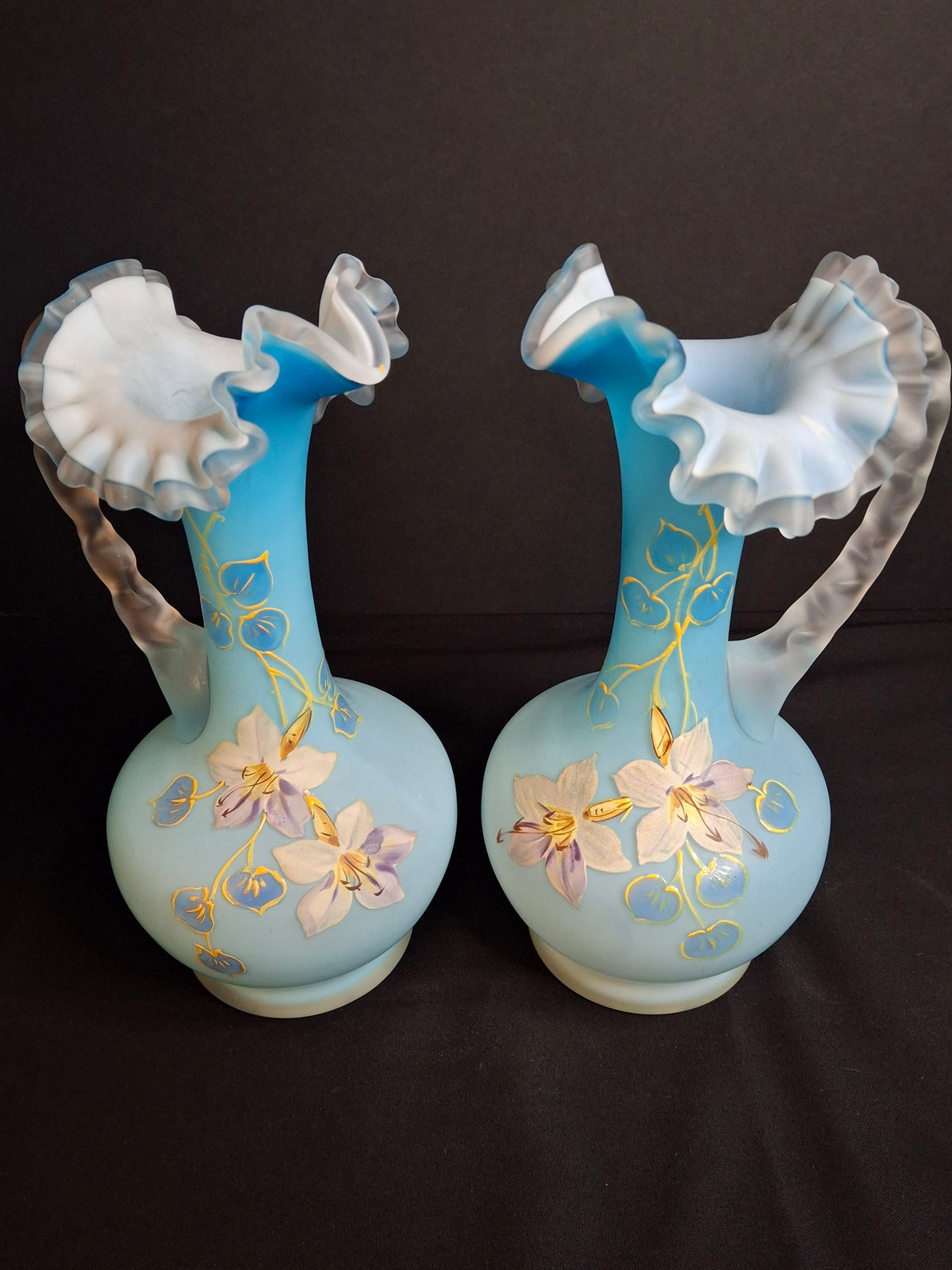 Antique Pair Victorian Blue Satin Cased Glass Pitcher Ewers Hand Painted Orchids Frosted Coral Branch Handles Ruffled Rim